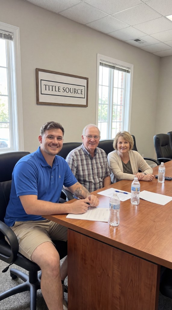Happy sellers closing at title company with Home Pros