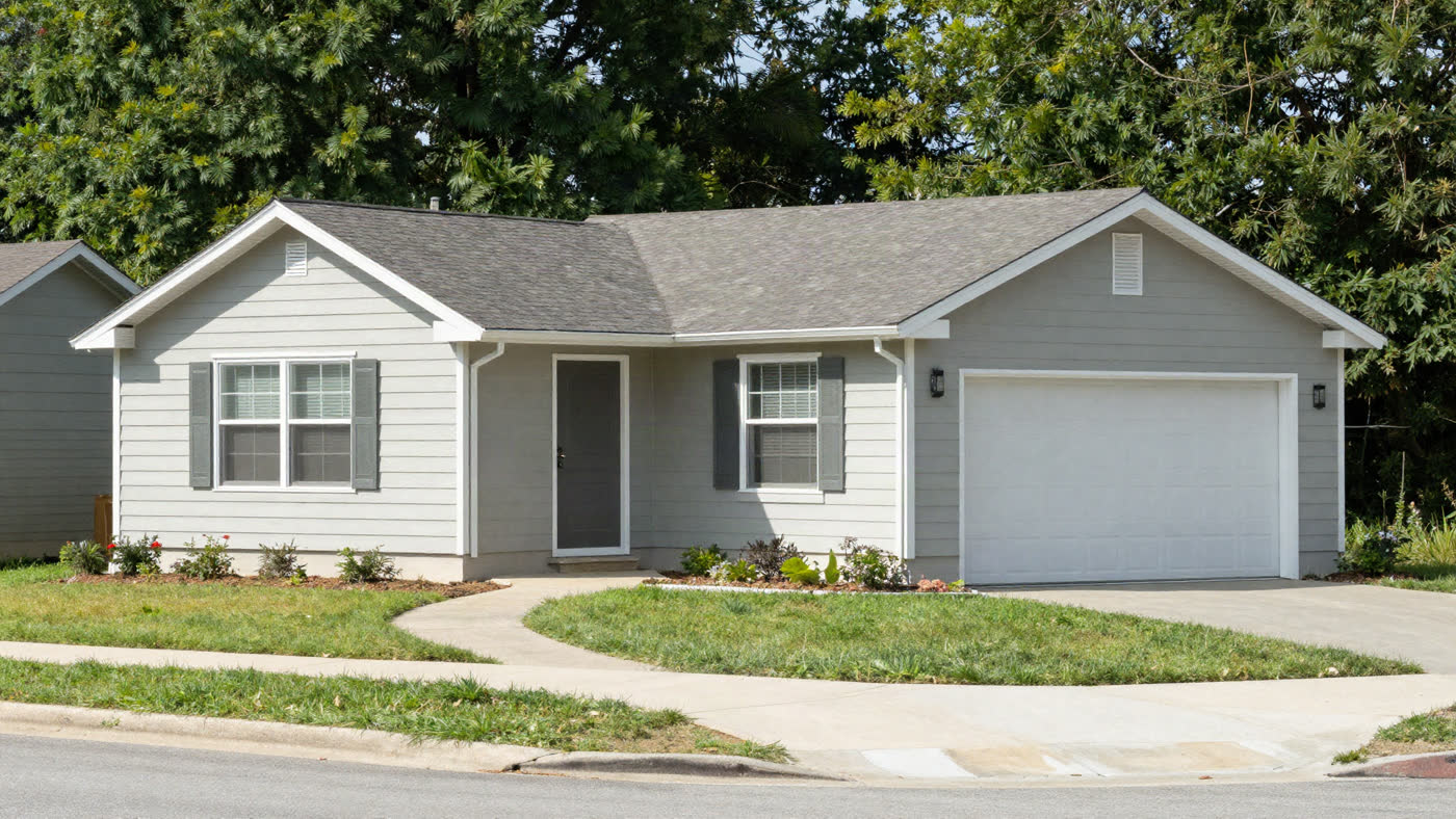 Bright, well-maintained single-family home with a clean front yard and covered porch, the kind of house a legitimate cash buyer purchases