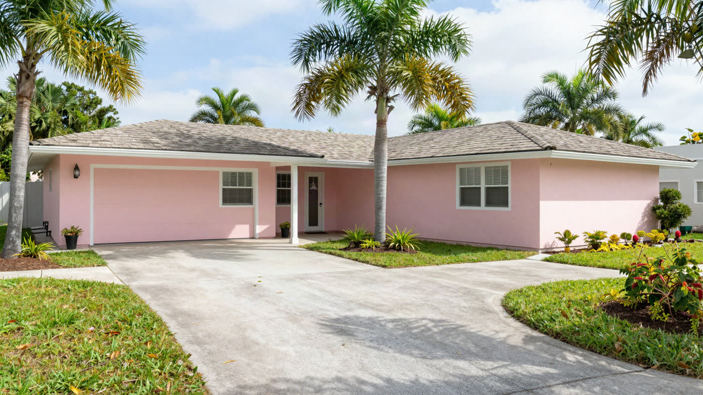 Bright, tidy single-story Florida home with mature palm landscaping, the kind of paid-off house a senior can sell as-is without repairs