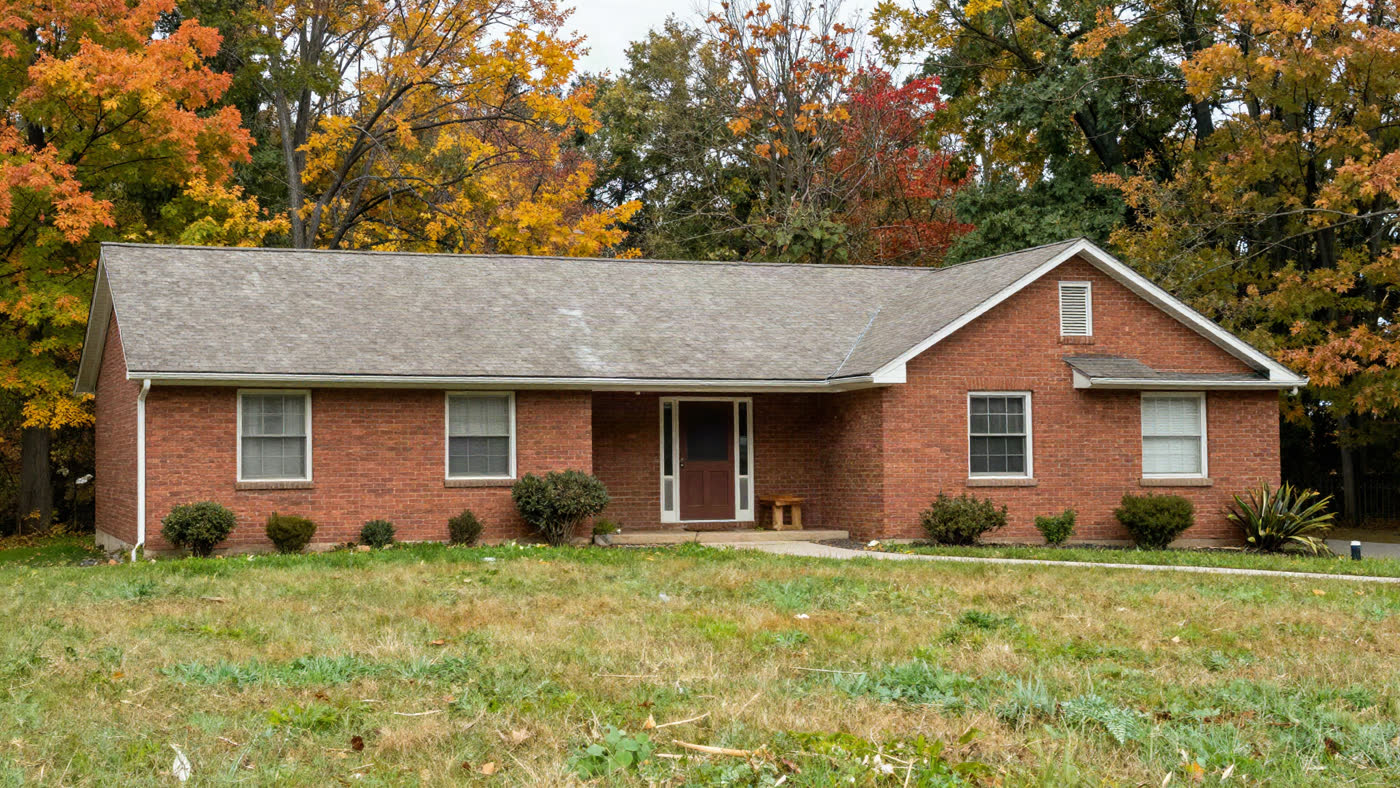 Bright, well-maintained upstate New York single-family home with autumn curb appeal, the kind of property that changes hands at a county in rem tax foreclosure auction